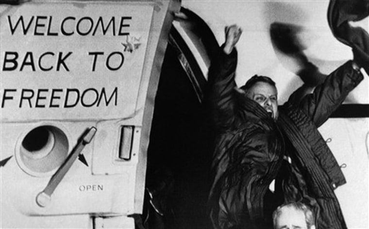 In this Jan. 21, 1981 file photo, freed U.S. hostage David Roeder shouts and waves as he arrives at Rhein-Main U.S. Air Force base in Frankfurt, Germany. Roeder was among 52 Americans held hostage in Iran for 444 days after their capture at the U.S. Embassy in Tehran.